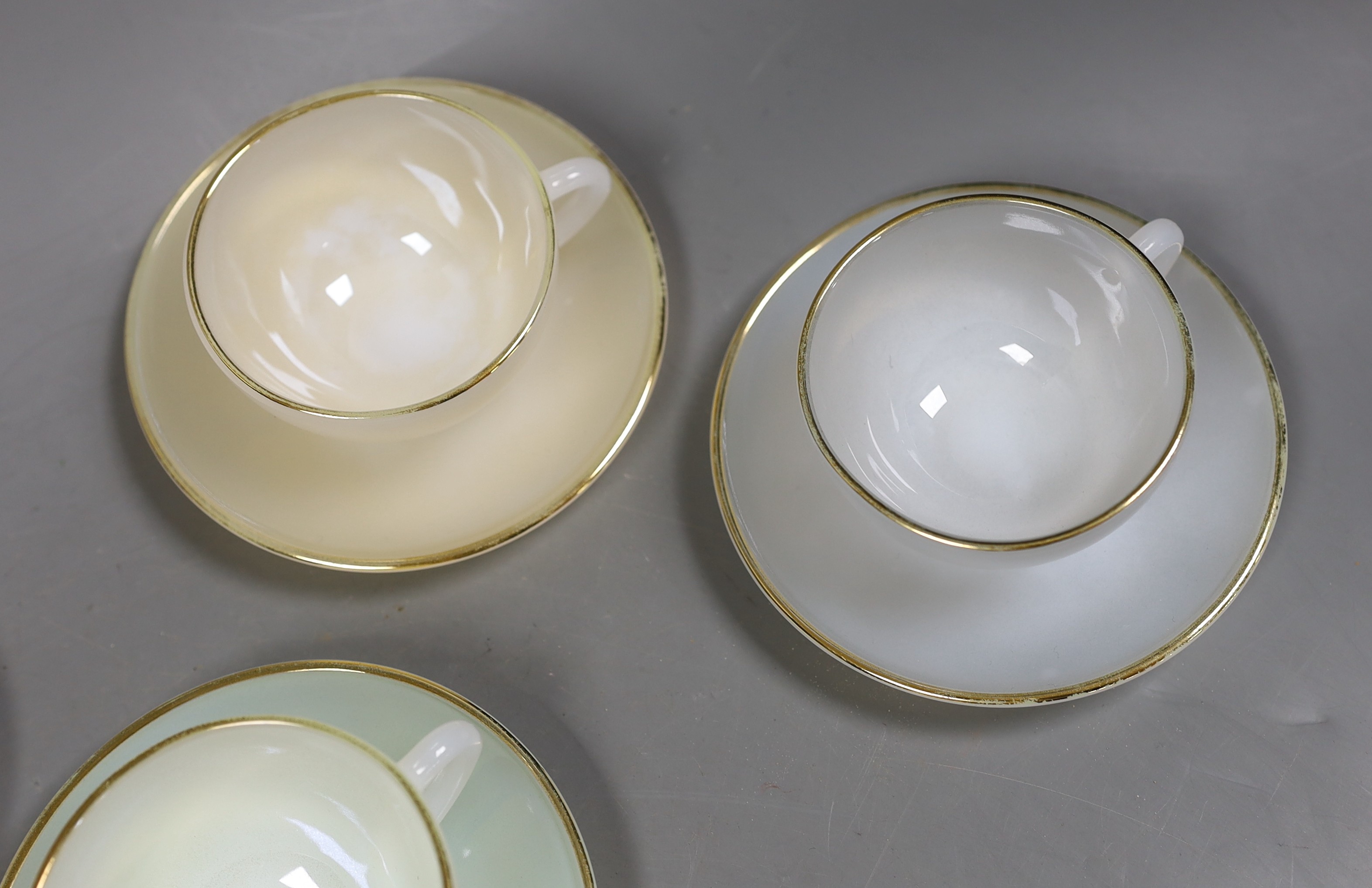 A set of six opalescent glass cups and saucers